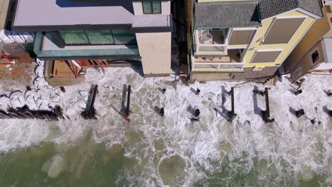 Huge wave explodes against beachfront homes and broken pilings in Long Beach Video stock 347919481