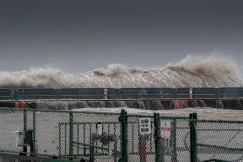 Huge Wave Towering Over Break Wall Just Before Impact Lake Michigan Milwaukee WI Stock Photos