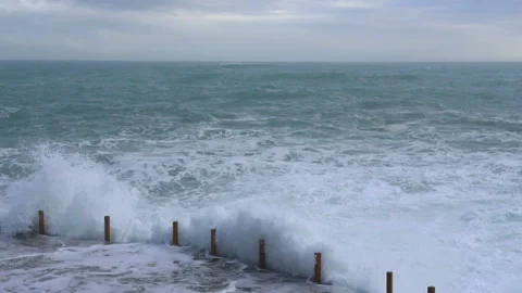 Huge waves break on the stone coast, slow motion Stock Footage 102581527