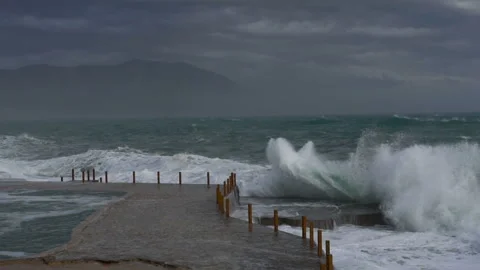 Huge waves break on the stone coast, slow motion Stock Footage 102593979