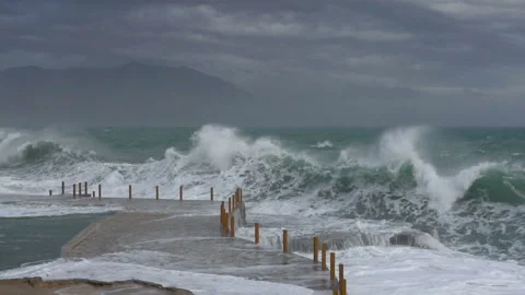 Huge waves break on the stone coast, slow motion Stock Footage 102601466