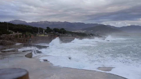 Huge waves break on the stone coast Stock Footage 102747238