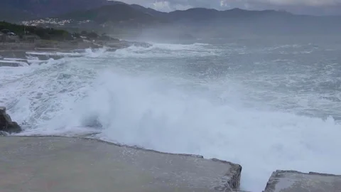 Huge waves break on the stone coast, slow motion Stock Footage 102816995