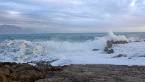 Huge waves break on the stones Stock Footage 102773682