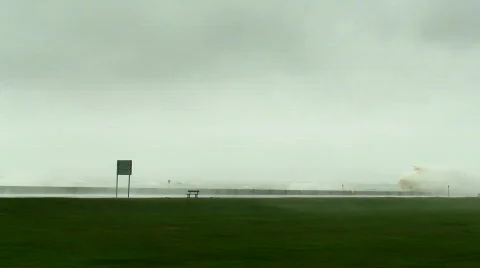 Huge waves breaking over sea wall 4 Stock Footage 673520