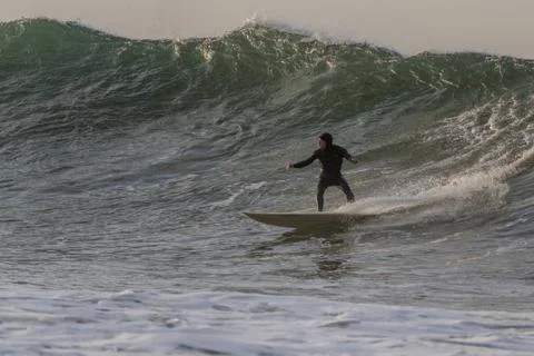 Huge waves challenge only the bravest surfers. Stock Photos