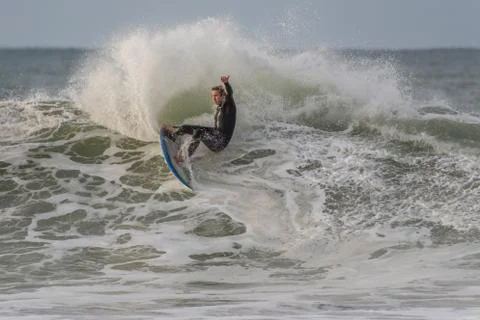 Huge waves challenge only the bravest surfers. Stock Photos