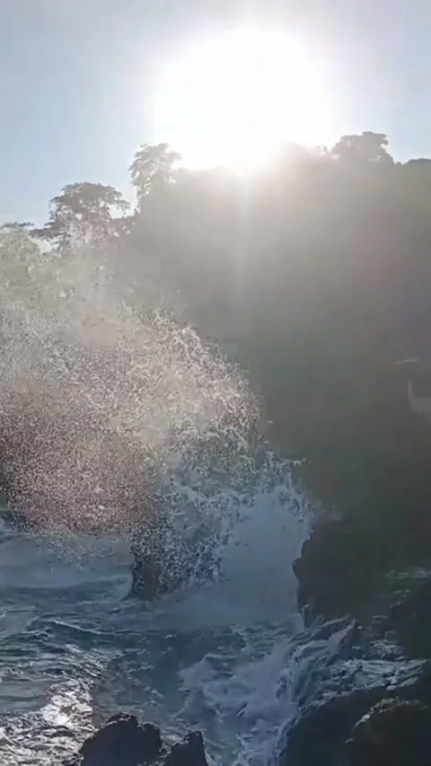 Huge Waves Crash Against Cliffs As Sunlight Penetrates Stock Footage 311308583