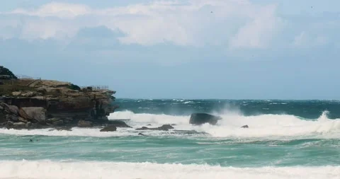 Huge waves crash on the rock faces in slow motion at north bondi sydney aust Stock Footage 137623567