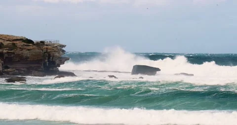 Huge waves crash on the rock faces in slow motion at north bondi sydney aust Stock Footage 137623669