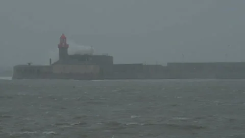Huge waves crashing on lighthouse in Dun Laoghaire. Emma storm in Dublin Stock-Footage 86656726