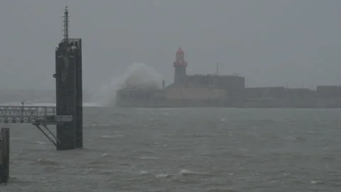 Huge waves crashing on lighthouse in Dun Laoghaire. Emma storm in Dublin Stock Footage 86661229