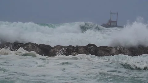 Huge waves over wavebreaker, slow motion Stock Footage 182274794