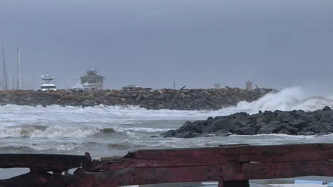 Huge waves overcome the protective barriers Stock Footage 263538457