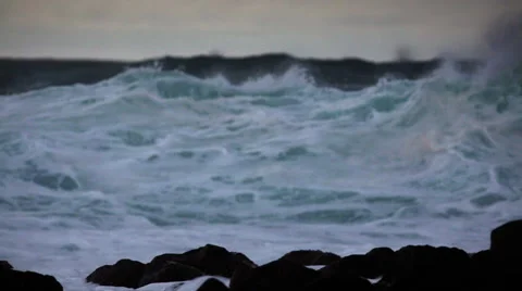 Huge waves roll in and crash against a rocky shoreline. Stock Footage