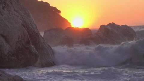 Huge waves splash on the rocks of Myrtos beach in Kefalonia Greece at sunset Stock Footage 151304846