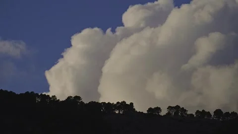 Huge white clouds are moving fast in the mountains. Stock Footage 262855568