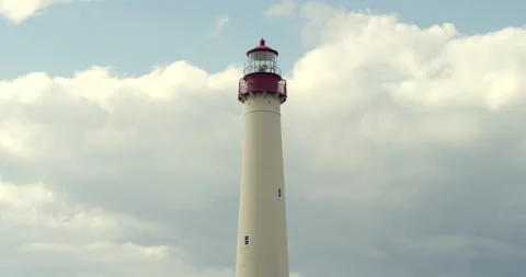 A huge white lighthouse on a cloudy sky background Stock Footage 144987039