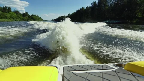 Huge white water wake behind a speeding boat on a river Stock Footage 338343967