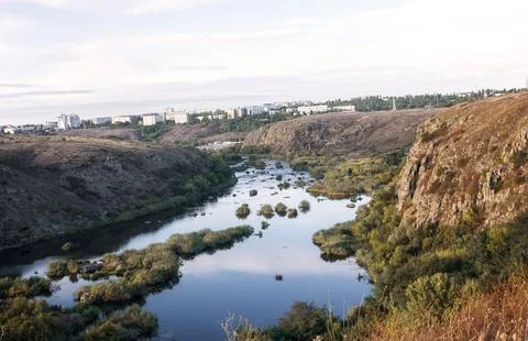 A huge wide river flows between steep banks Stock Photos