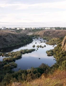 A huge wide river flows between steep banks Stock Photos