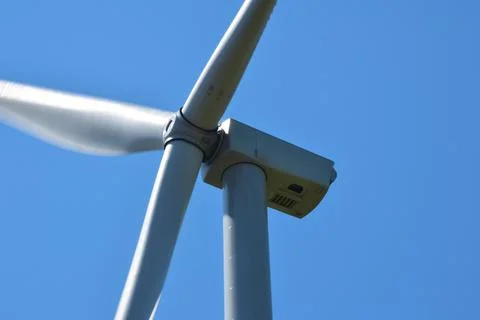 Huge wind generator close up against the background of a bright clear sky Stock Photos