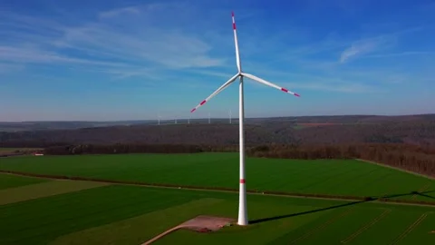 Huge wind generators on a green field Wind generators Stock Footage 154337557