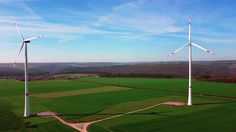 Huge wind generators on a green field Wind generators Stock Footage 154337630