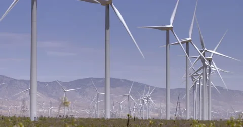 Huge wind turbines operating in desert near the Tehachapi Mountains 4K Stock Footage 64284104