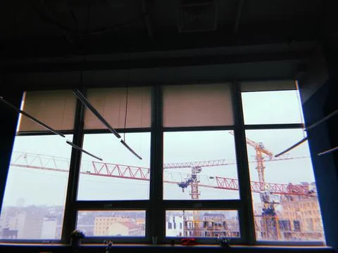 A huge window with two crane behind it Stock Photos