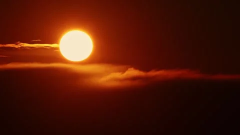 A huge yellow round sun sets behind dark tense clouds Stock Footage 255041918