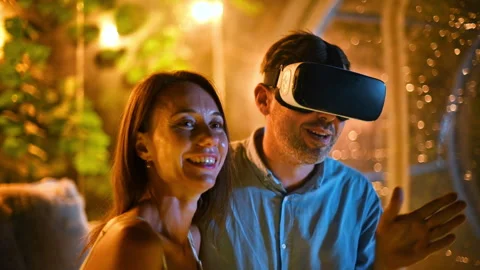 A hugging couple inside transparent bubble tent at glamping at night while man Stock Footage 250360750