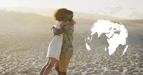 Hugging couple sharing embrace on sandy dune under golden light, with dotted map Fotos Stock