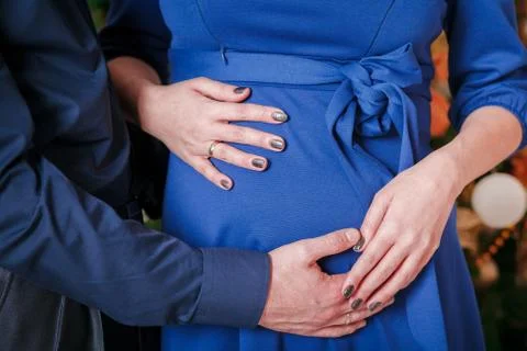 Hugs pregnant belly man's hand Stock Photos