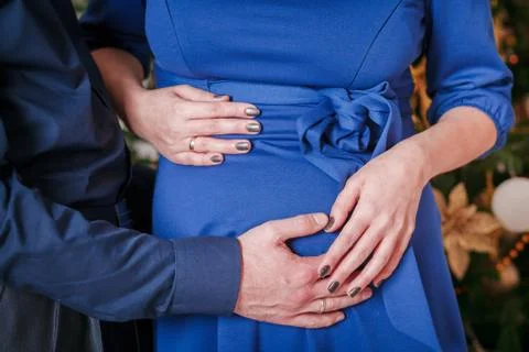 Hugs pregnant belly Stock Photos