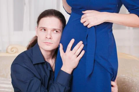 Hugs pregnant couple Stock Photos
