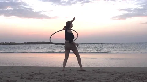 Hula hoop at the beach at sunset Stock Footage 35180651