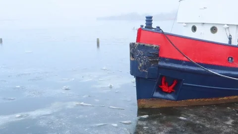 Hull of an old ship in ice covered sea water, Irvine harbour, Ayrshire, Scotland Stock Footage 225717631