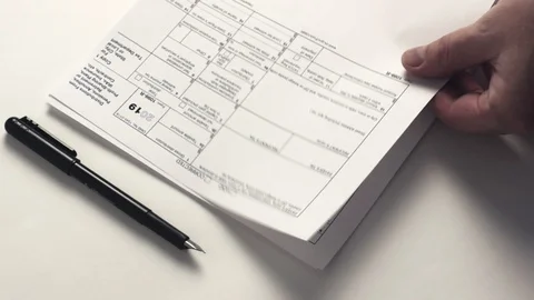 Human add up tax forms Stock Footage 102359963