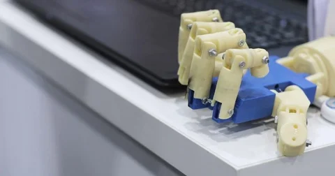 A human and a bionic hands lying beside each other. Top view. Man with Stock Footage 76946706