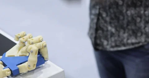 A human and a bionic hands lying beside each other. Cybernetic robot arm, which Stock Footage 76947231