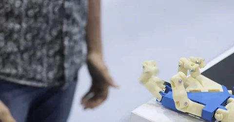 A human and a bionic hands lying beside each other. Top view. Man with Stock Footage 76947798