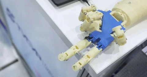 A human and a bionic hands lying beside each other. Top view. Man with Stock Footage 76948350