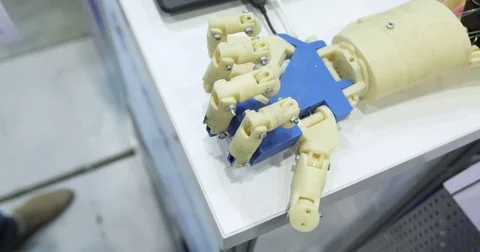 A human and a bionic hands lying beside each other. Cybernetic robot arm, which Stock Footage 76949136