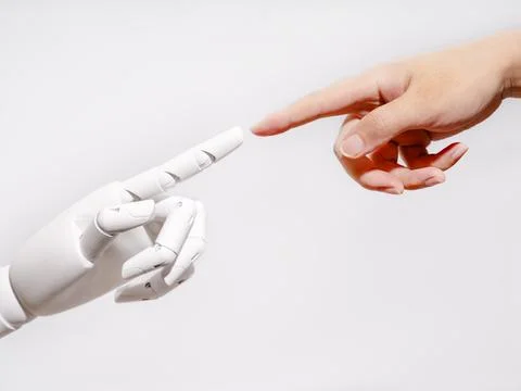 Human and robot fingertips touching 스톡 사진