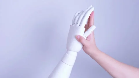 Human and robot hands giving a high-five Stock Footage 317211637