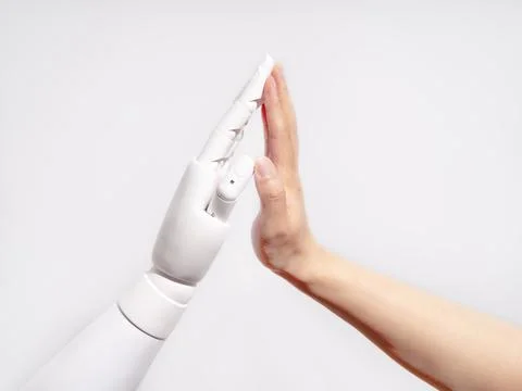 Human and robot hands touching Stock Photos
