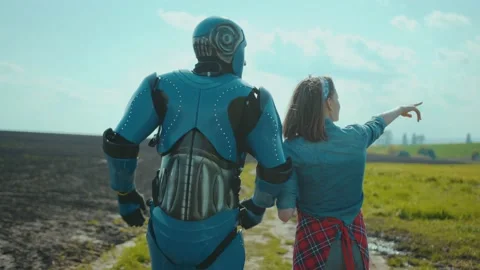 Human and robot workers cooperating at agricultural field. Young woman teaching Stock Footage 132840064