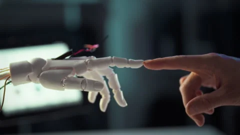 Human and robotic hand engage in a moment of connection in a high-tech envir Stock Footage 323865059