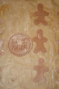 Human and round shape gingerbreads on brow paper during preparation. Home mad Stock Photos